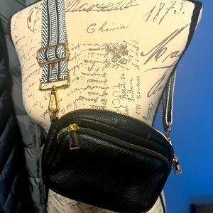 Pom Pom London leather black crossbody w/ black and white strap.